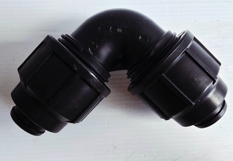 A 90-degree poly pipe elbow fitting.