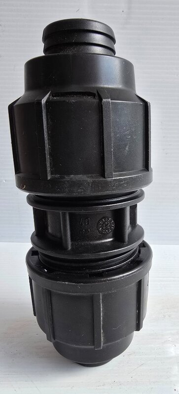 A poly pipe reducing coupling.
